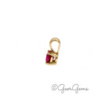 Side view of a 4mm ruby pendant in 9k yellow gold